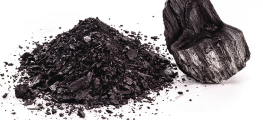 pile of coal dust isolated with piece of charcoal on white background