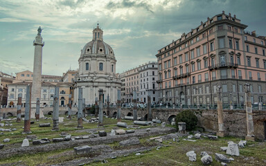 Fototapeta premium Rome Italy, picturesque view of the Trajan forum under dramatic cloudy sky and sun rays