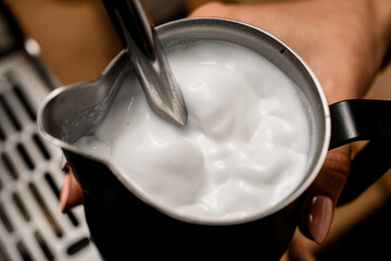 Great close-up view of fresh whipped foam of cream in jug