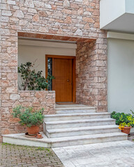 Fototapeta na wymiar elegant house front marble stairs and natural wood door, Athens Greece