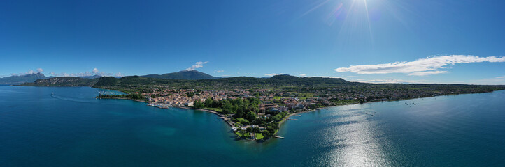 Panorama of the historic town of Bardolino. Aerial view of Bardolino, Lake Garda, Italy. Top view of the historic part of the city of Bardolino on the coastline of Lake Garda.