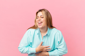 curvy pretty blonde woman laughing out loud at some hilarious joke