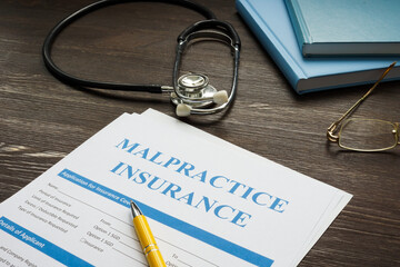 Medical malpractice insurance application with stethoscope.