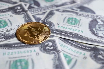 closeup of  bitcoin cryptocurrency coins on US dollar bills. electronic money concept.