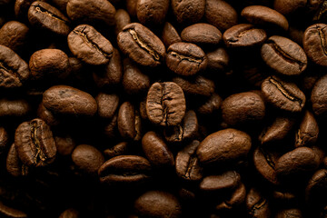 view of dark roasted coffee beans. Seamless coffee beans background.