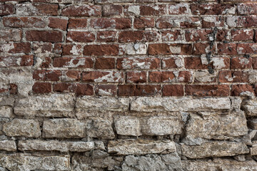 Old grungy rustic dirty dusty brick wall of ancient city. Uneven pitted peeled surface brickwork of cellar worn.Ruined rusty red stiff blocks. Spotted messy ragged holes brickwall for 3D grunge design