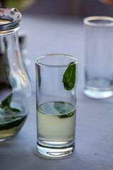 still life with a decanter and a glass with the leftover lemonade on the table 