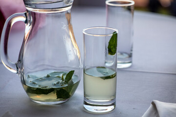still life with a decanter and a glass with the leftover lemonade on the table 