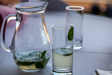 still life with a decanter and a glass with the leftover lemonade on the table 