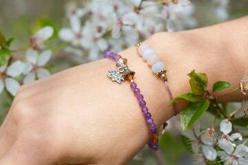 Female hand wearing popular gemstone mineral bead yoga bracelets - 434153884