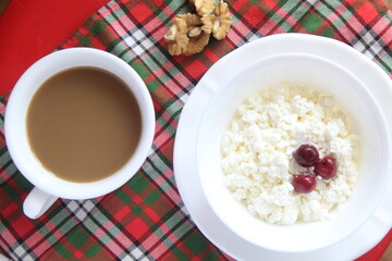 cup of coffee with milk and cottage cheese and cherry curd light breakfast