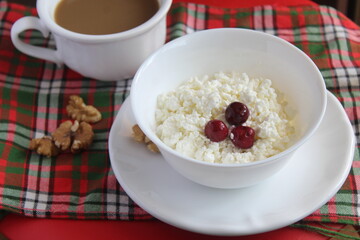 white healthy curd cheese with cherry nuts and cup of coffee breakfast