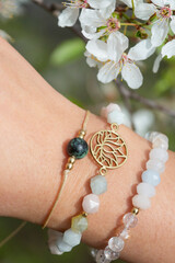Female hand wearing popular gemstone mineral bead yoga bracelets - 434154068