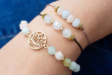 Female hand wearing popular gemstone mineral bead yoga bracelets