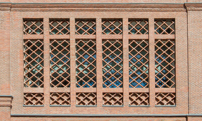 A lattice made of bricks on the facade of a building