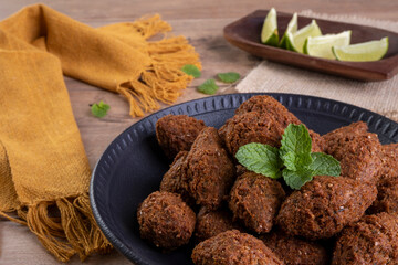 Traditional Arabian fried snack made with wheat and stuffed with minced meat. Quibe