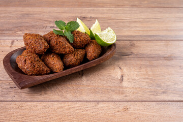 Traditional Arabian fried snack made with wheat and stuffed with minced meat. Quibe