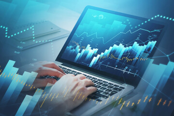 Businessman hands or stock trader analyzing stock graph and financial indicators of market using laptop to buy or sell shares, internet trading