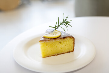 Closeup view of a beautiful lemon souffle cheesecake on a white plate