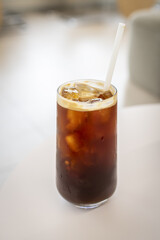 Closeup view of a glass of a refreshing iced coffee on a blurred background