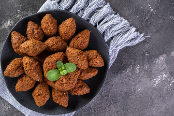 Traditional Arabian fried snack made with wheat and stuffed with minced meat. Quibe