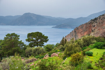 View of the Aegean Sea from the Lycian Trail near Faralya and Oludeniz villages with mountains and gardens
