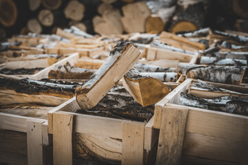 Set of cut firewood. Firewood in wooden crates. Piles of firewood.