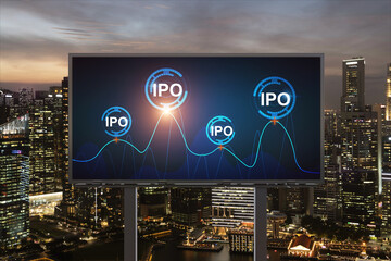 IPO icon hologram on road billboard over night panorama city view of Singapore. The hub of initial...