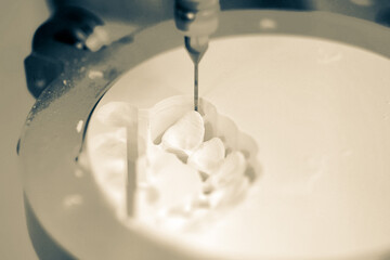Dental milling machine carving out shape of human teeth
