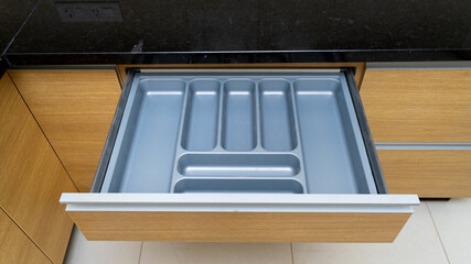 Empty cutlery tray in a wooden shelf