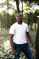 A young black man in park. Outdoor portrait of traveler. Portrait of a young african man outdoors. Outdoors portrait concept.