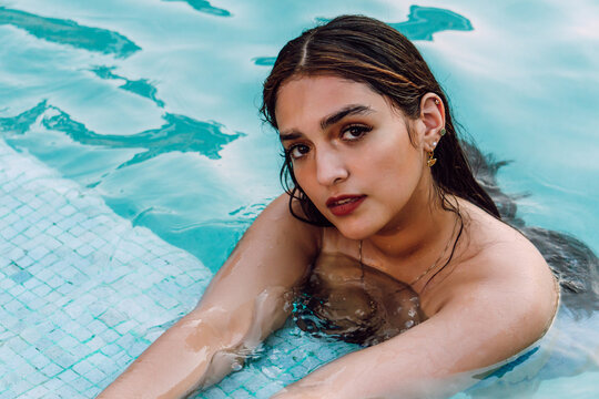 Female tourist in swimwear in pool