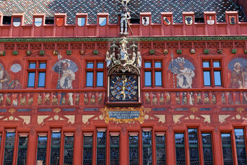 basel switzerland, april 25. 2021: red city hall, front view with clock and swiss cantonal coat of...