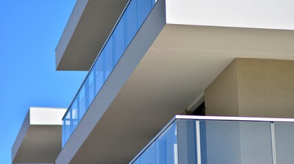 Condominium and apartment building with  symmetrical modern architecture. Detail in modern residential flat apartment building exterior. Fragment of new luxury house and home complex. 