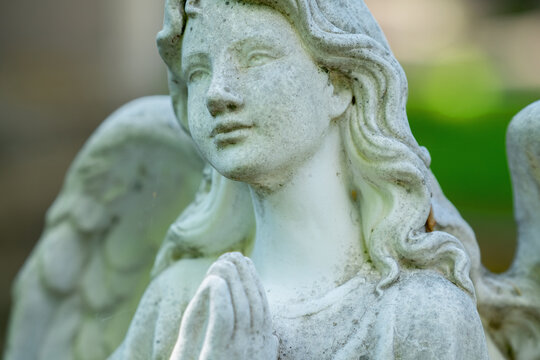 Tender beautiful angel praying. Fragment of an  ancient statue.