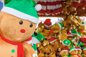 Stuffed toy gingerbread man displayed as awards for winning prizes at London winter wonderland funfair 