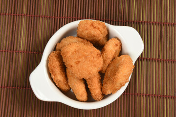 A portion of breaded chicken in a ceramic bowl