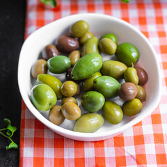 olive pitted plate on the table varieties fruits vegan vegetarian food snack trend meal copy space...