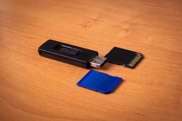 Flash drive. Memory card.Wood background.Memory drives on the table.