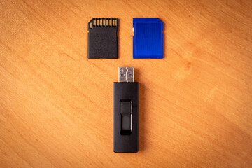Flash drive. Memory card.Wood background.Memory drives on the table.
