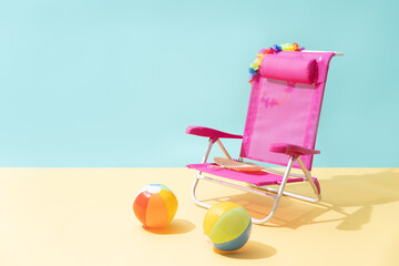 pink beach chair with two beach balls