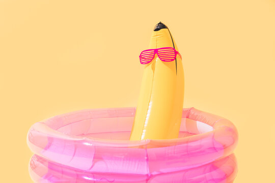 children's pool with a banana-shaped inflatable banana with sunglasses