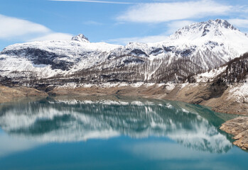Mountains with snow and lake in the French Alps Tignes