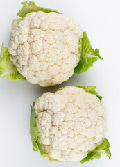 A head of fresh cauliflower. Healthy eating and vegetarianism. Color background.