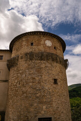 Fototapeta na wymiar Closeup of an ancient medieval tower with clock, Tuscany, Italy.