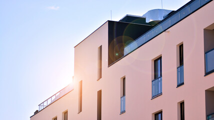 Apartment residential house and home facade architecture and outdoor facilities. Blue sky on the background. Sunlight in sunrise.