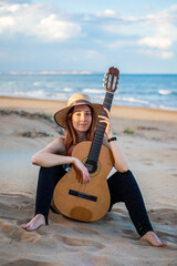 beautiful girl plays guitar in the beach