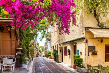 Foto op Canvas Beautiful view to the little streets of the old town Plaka of Athens, Greece with colorful houses and blooming bougainvillea flowers © moofushi