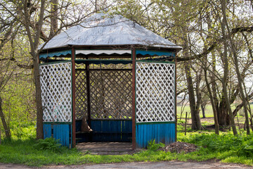 old wooden gazebo in the forest