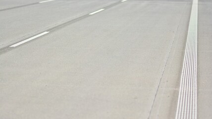 Fototapeta premium Straight modern concrete motorway with bright road marking. Transportation road system infrastructure. 